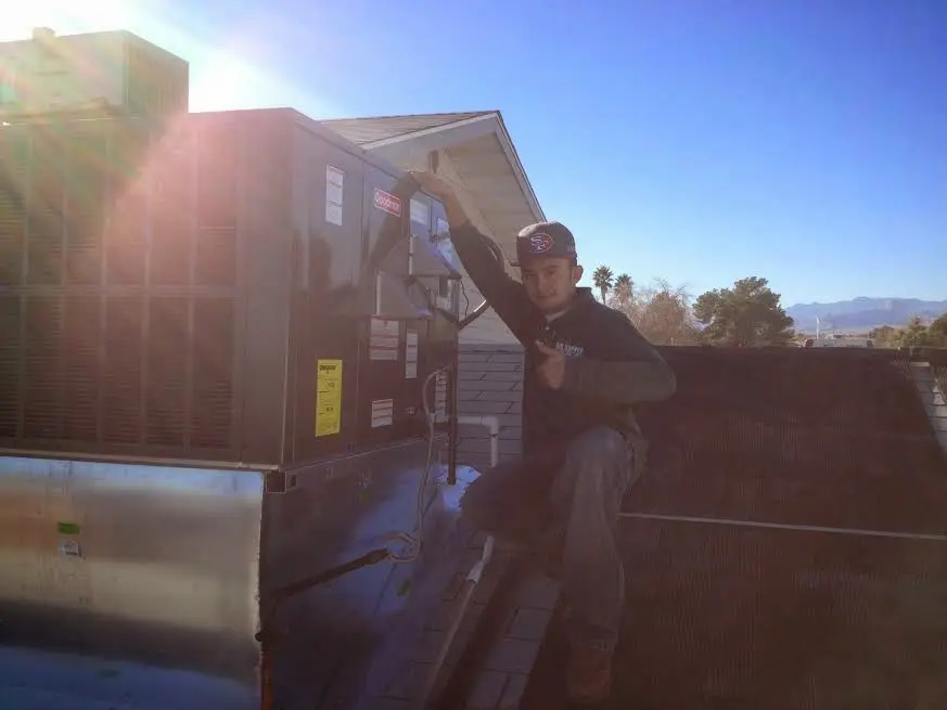 HVAC technician performing HVAC Inspection on a rooftop unit in Gray